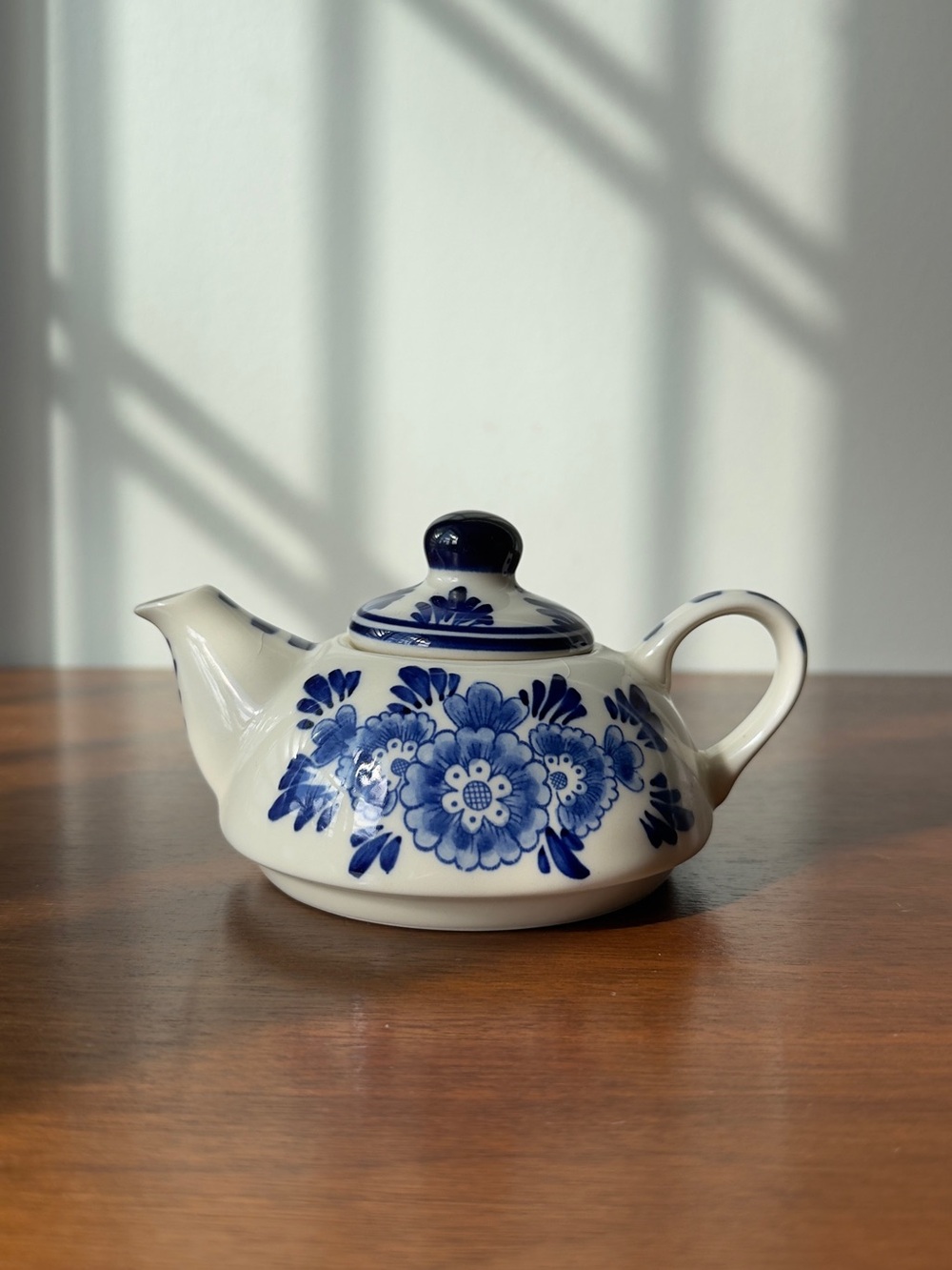 A mini hand painted teapot by Delft Blue.